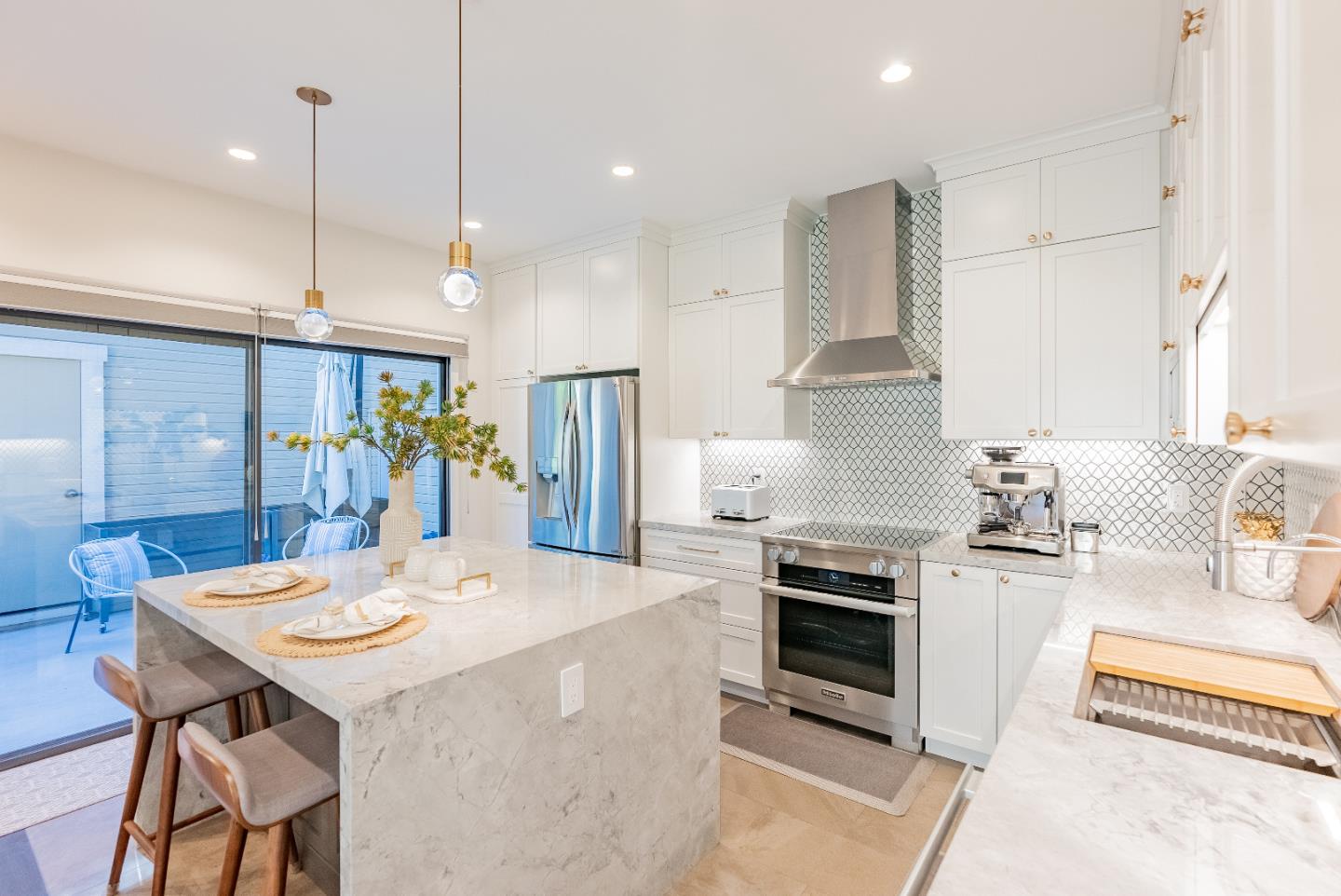 919 La Mesa Terrace, Unit E Sunnyvale, CA 94086 - Photo 9 of 34 a kitchen with stainless steel appliances kitchen island granite countertop a stove a refrigerator a kitchen island a sink and a refrigerator