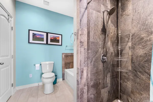 a bathroom with a toilet and a shower