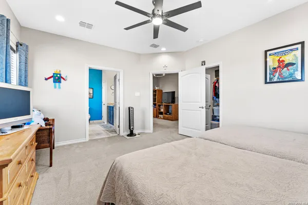 a bedroom with a bed and a desk