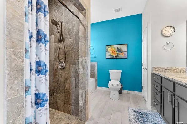 a bathroom with a toilet sink and shower