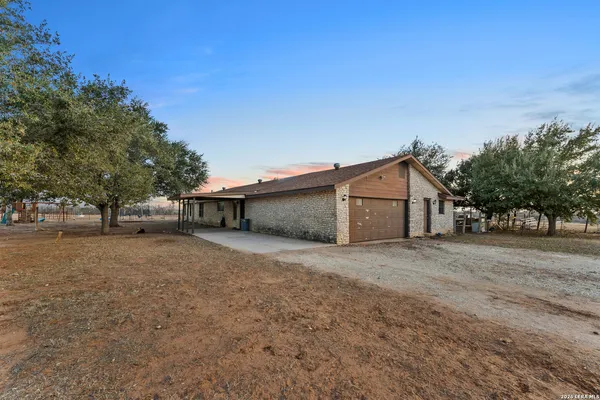 a dirt road with a building in the background