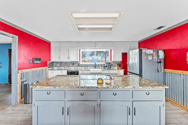 a kitchen with sink and cabinets