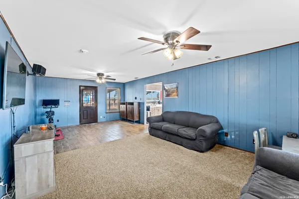 a living room with furniture and a ceiling fan