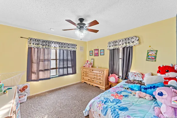 a bedroom with bed and a window