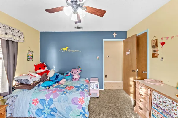 a bedroom with a bed a couch and dresser