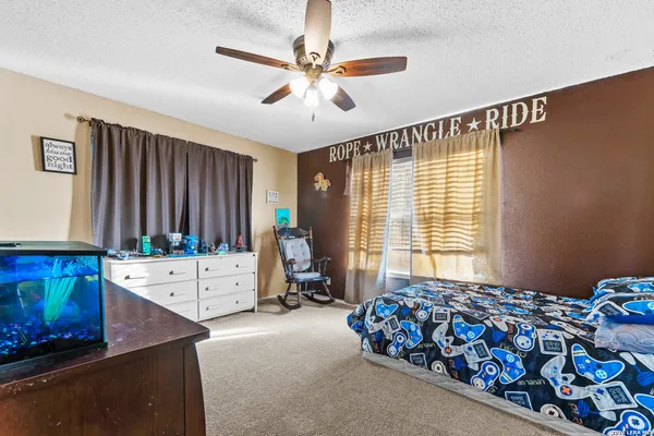 a large bedroom with a bed and a chandelier