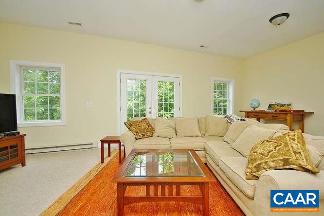 1029 Tilman Road Charlottesville, VA 22901 - Photo 30 of 33 a living room with a bed furniture and a window