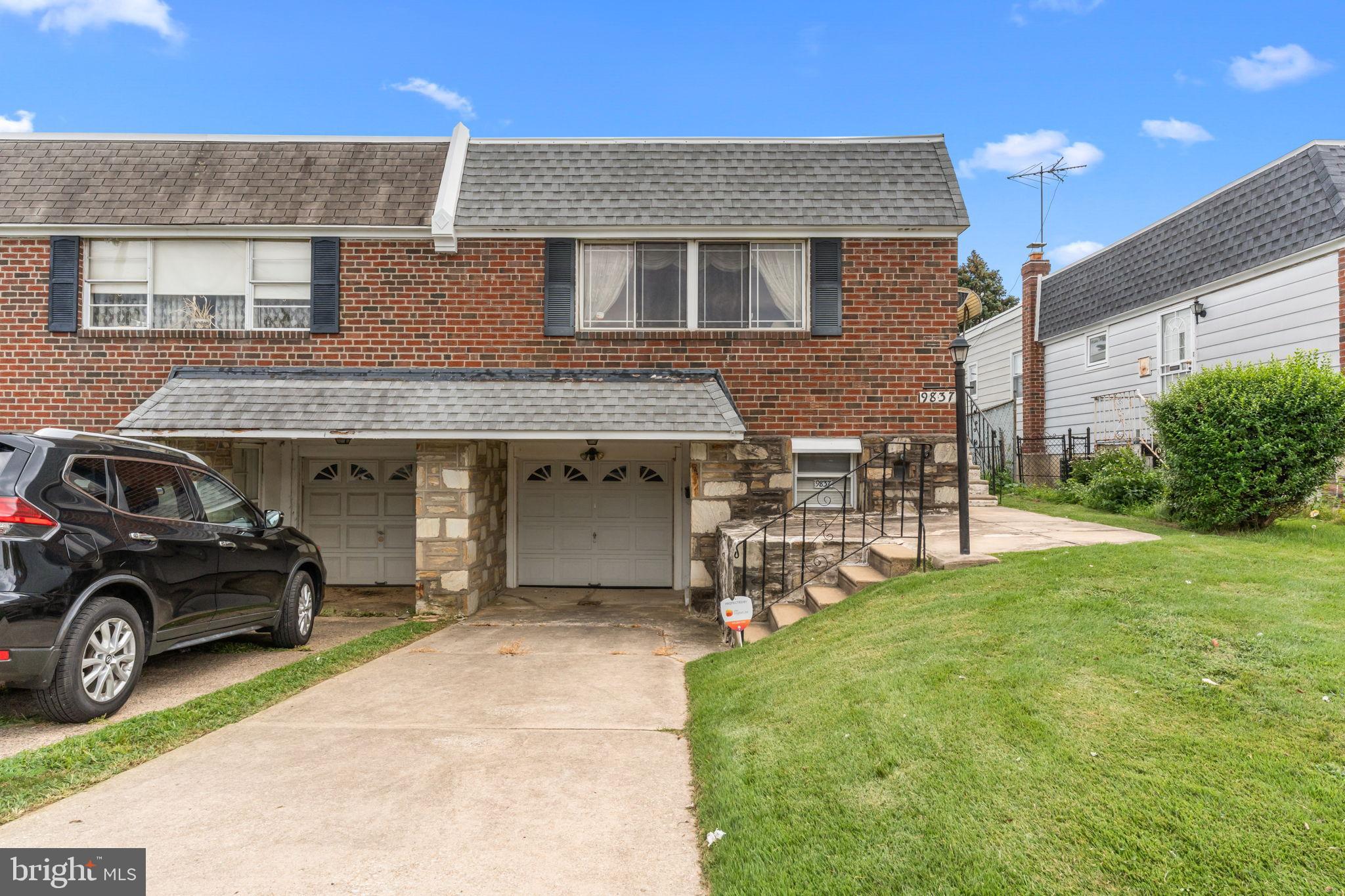 a car parked in front of a brick house