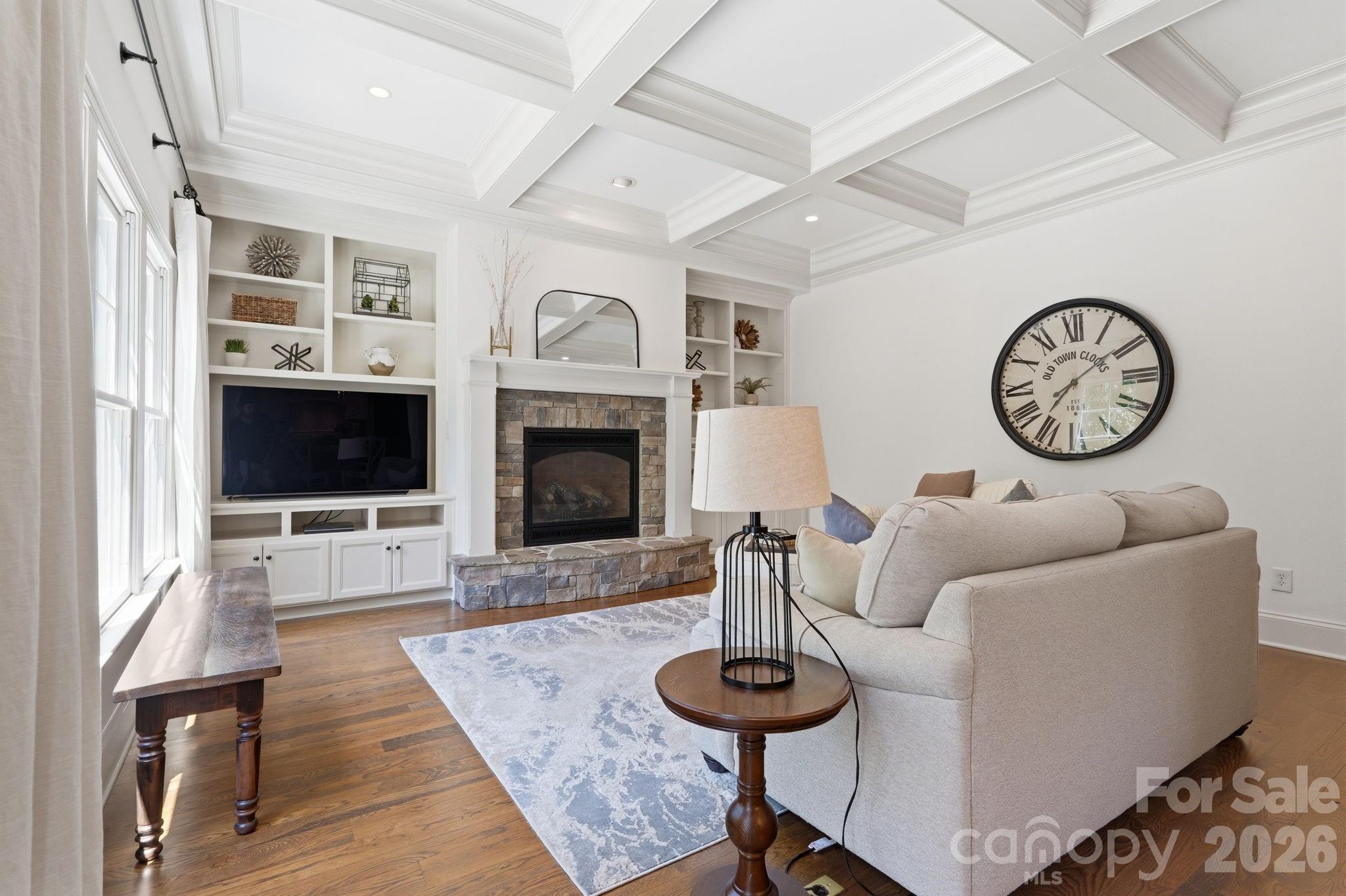235 Grey Road Davidson, NC 28036 - Photo 11 of 42 a living room with furniture a flat screen tv and a fireplace