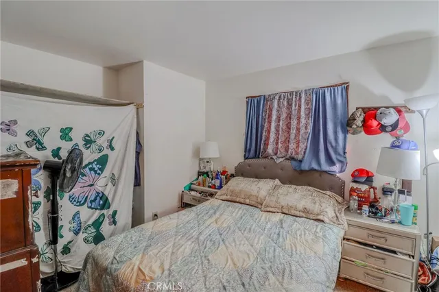 a bedroom with a bed and a dresser