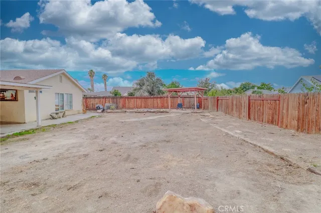 a view of a house with wooden fence