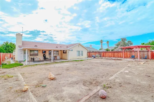 a view of house with backyard and trees