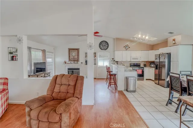 a living room with lots of furniture and kitchen view