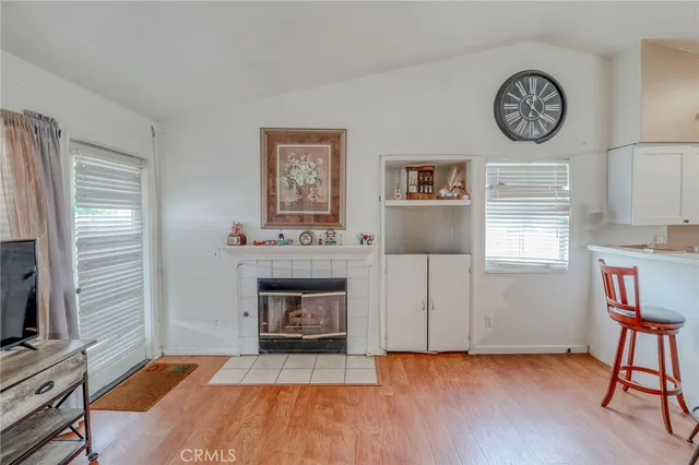 a view of livingroom with furniture a fireplace and wooden floor