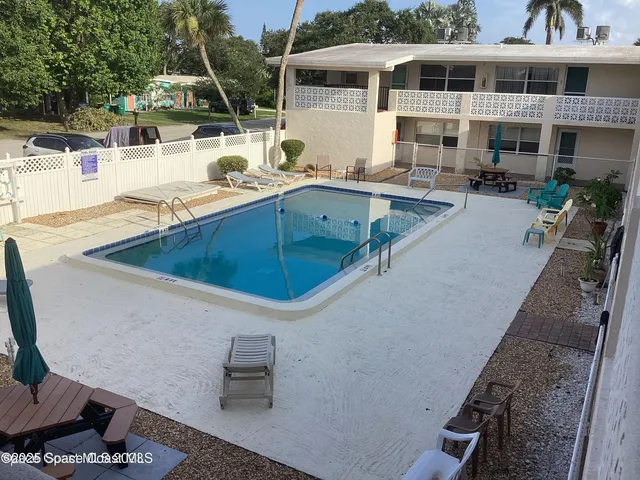 a swimming pool with outdoor seating and yard