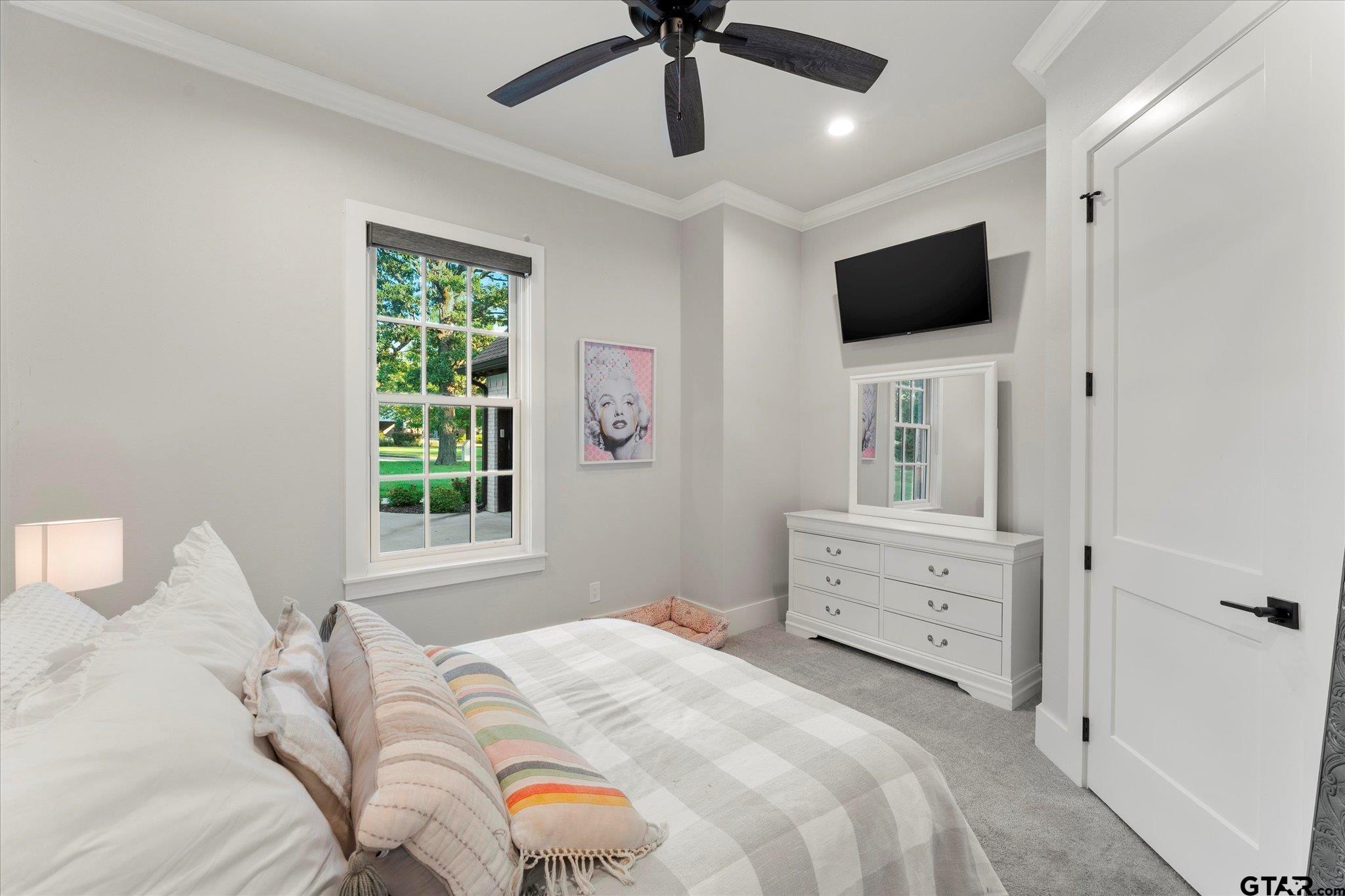 4301 Windrush Boulevard Longview, TX 75604 - Photo 20 of 36 a bedroom with a bed and a flat screen tv
