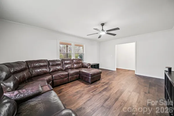 a living room with furniture and wooden floor