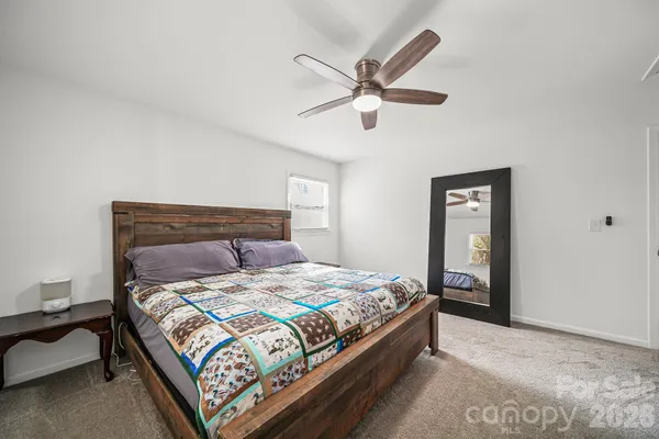 a bedroom with a bed and window