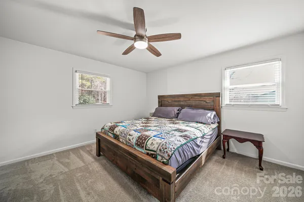 a bedroom with a bed lamp and a window