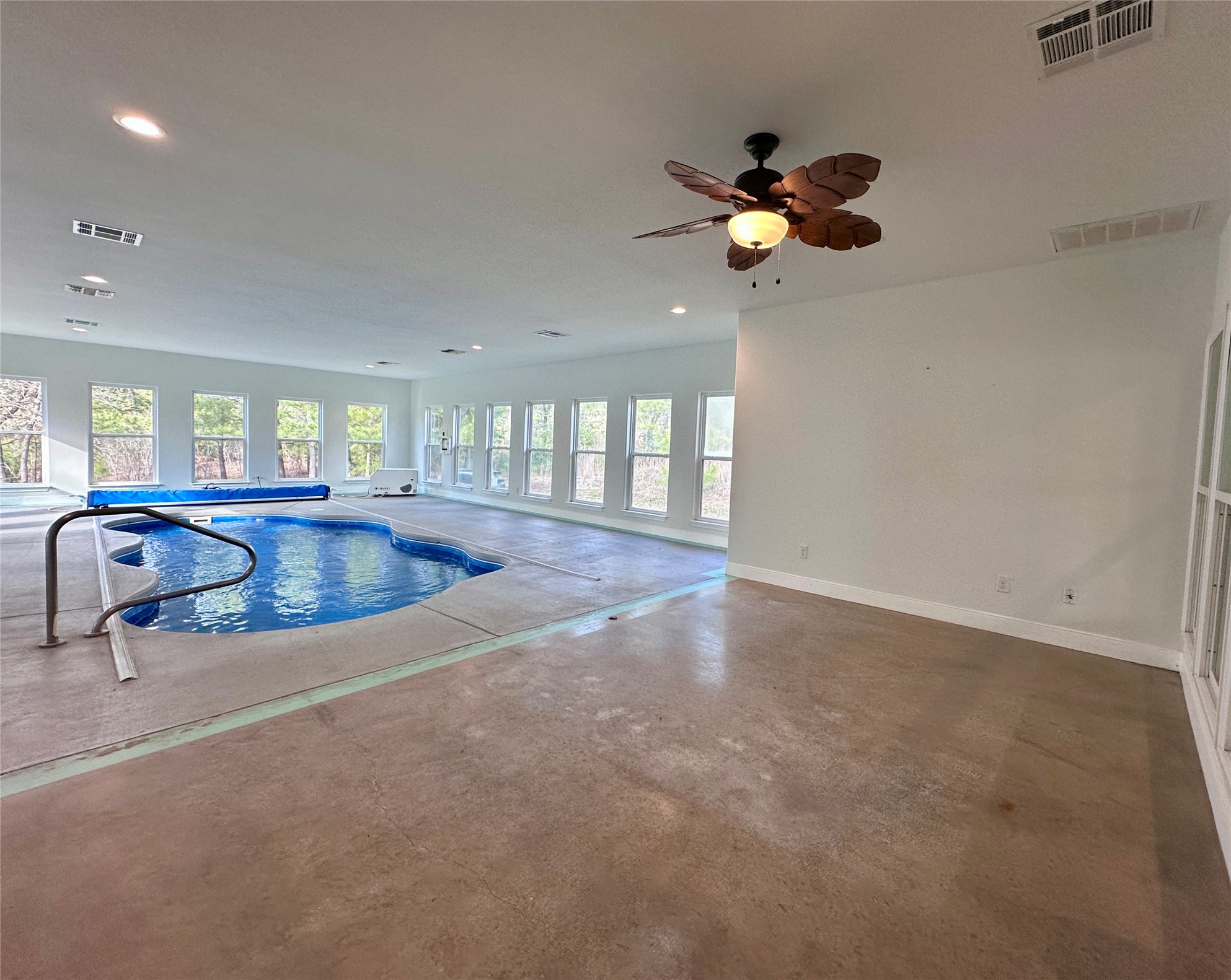 124 Pine Path Bastrop, TX 78602 - Photo 19 of 31 Completely indoor heated/cooled pool room with large concrete decks, Pool & ceiling fan