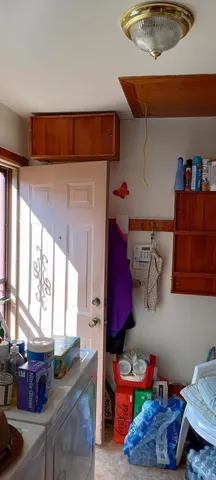 a kitchen with furniture and a potted plant