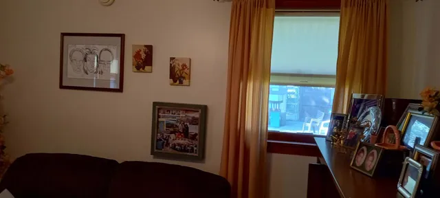 a view of a hallway with furniture and a window