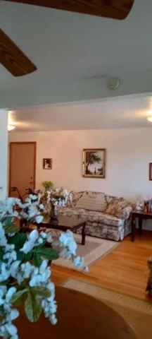 a living room with furniture and floor to ceiling window