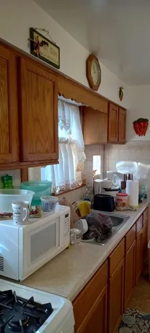 a kitchen with a sink a stove and cabinets