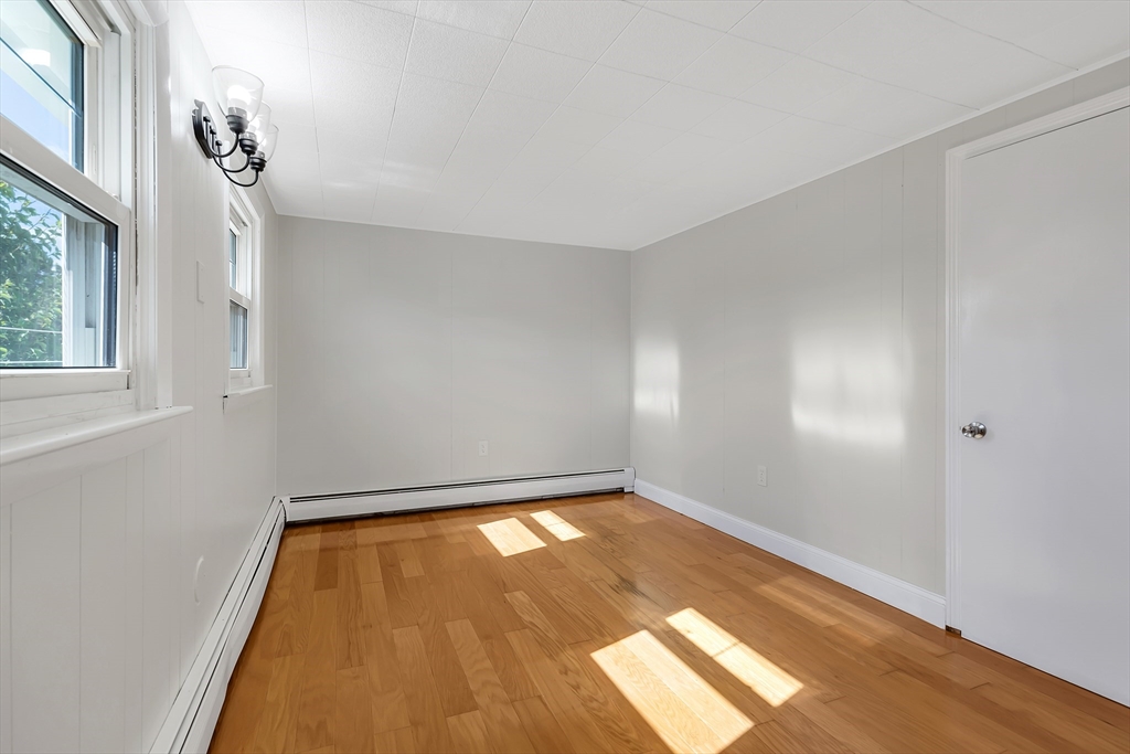 242 Welcome Street Fall River, MA 02721 - Photo 17 of 21 wooden floor in an empty room with a window