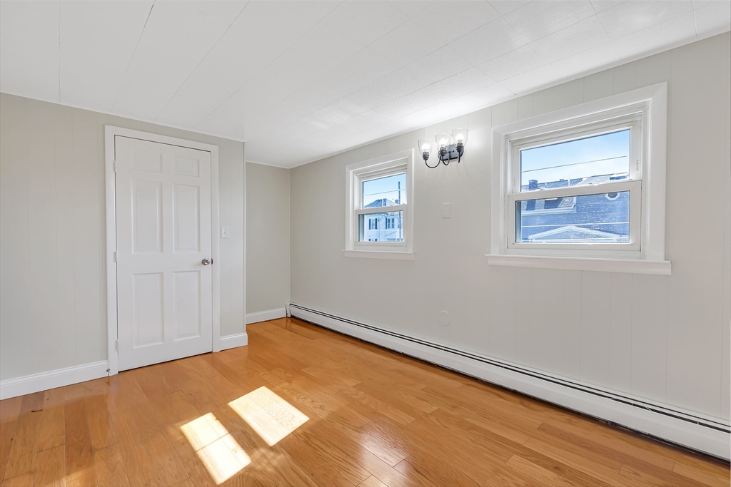 242 Welcome Street Fall River, MA 02721 - Photo 18 of 21 a view of an empty room with wooden floor and a window