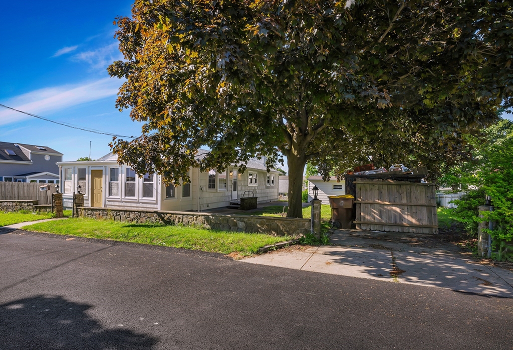 242 Welcome Street Fall River, MA 02721 - Photo 2 of 21 a front view of a house with a yard and trees