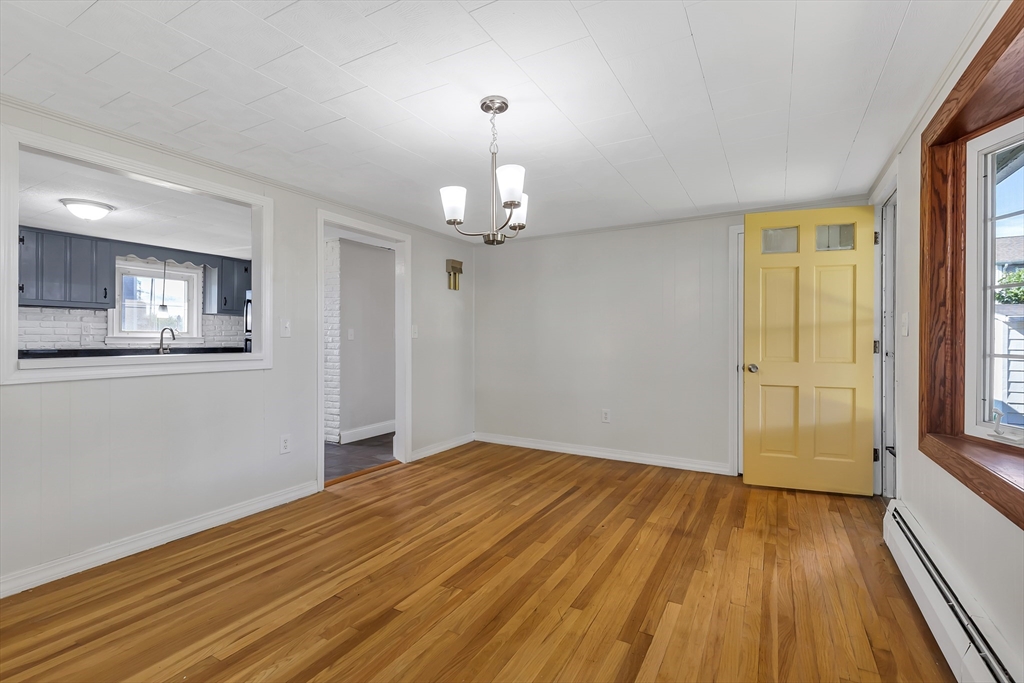 242 Welcome Street Fall River, MA 02721 - Photo 3 of 21 wooden floor in an empty room with a window