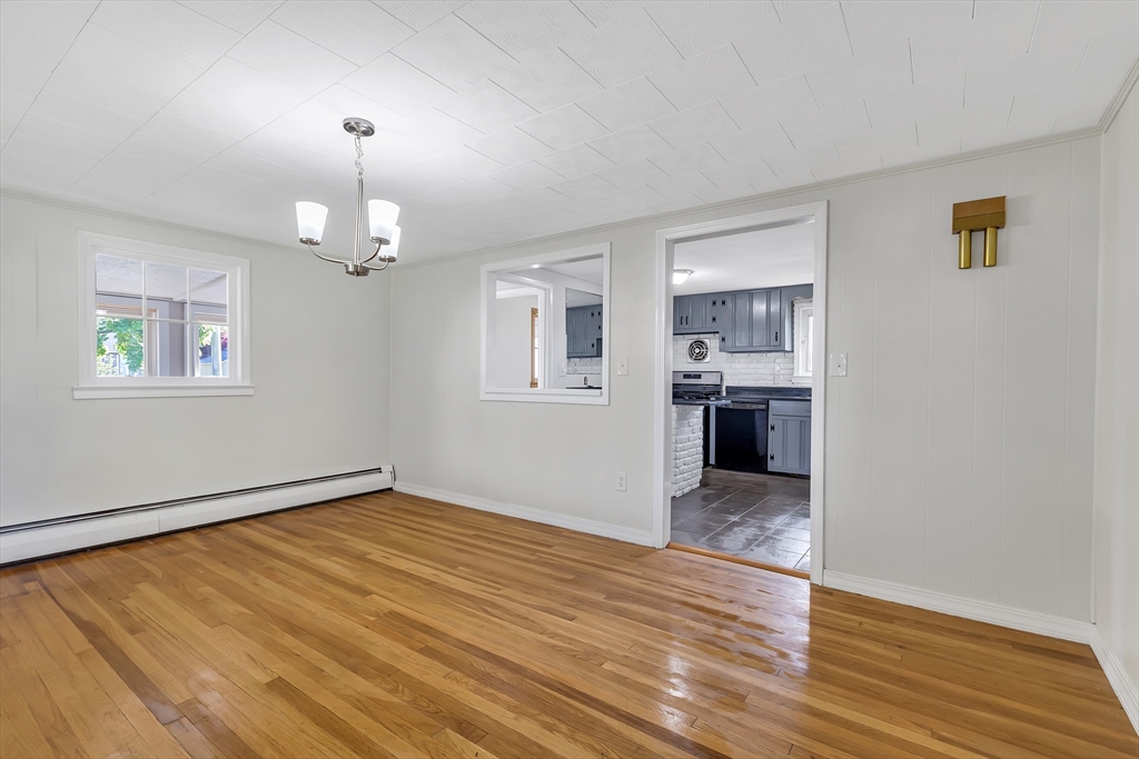 242 Welcome Street Fall River, MA 02721 - Photo 6 of 21 an empty room with wooden floor chandelier and windows