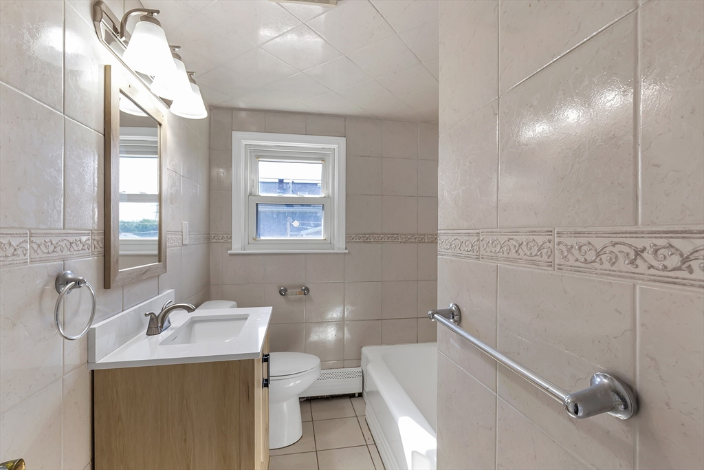 242 Welcome Street Fall River, MA 02721 - Photo 9 of 21 a bathroom with a granite countertop sink mirror and toilet