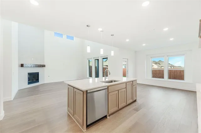 a kitchen with a sink and a stove top oven