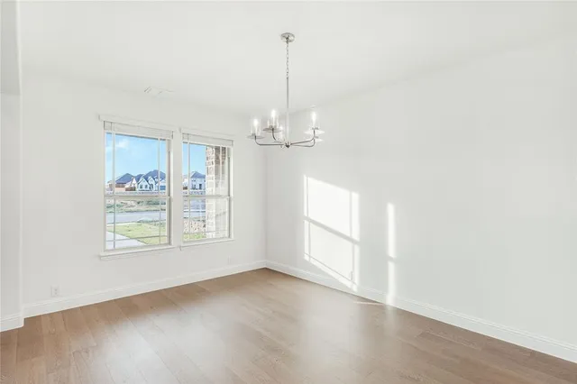 a view of a room with window and wooden floor