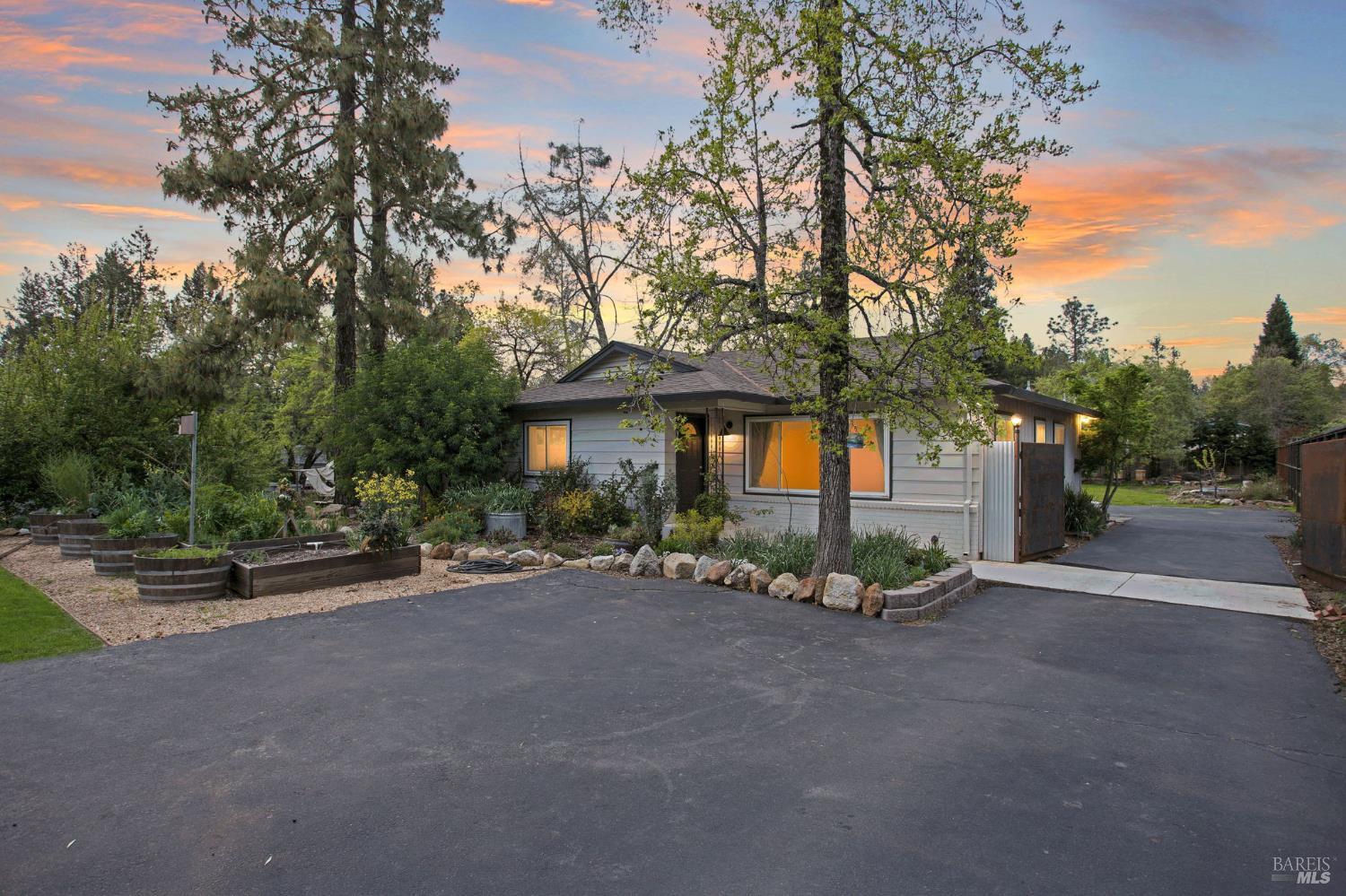 350 Newton Way Angwin, CA 94508 - Photo 1 of 44 a view of a house with potted plants and large trees
