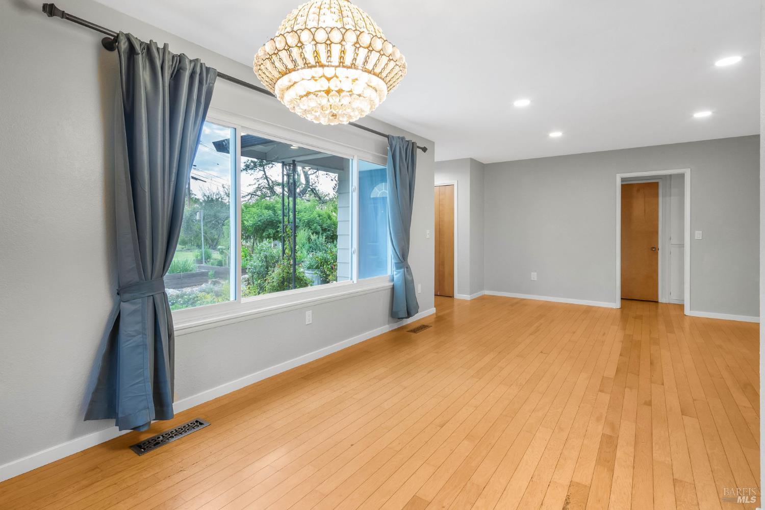 350 Newton Way Angwin, CA 94508 - Photo 14 of 44 a view of an empty room with wooden floor and windows