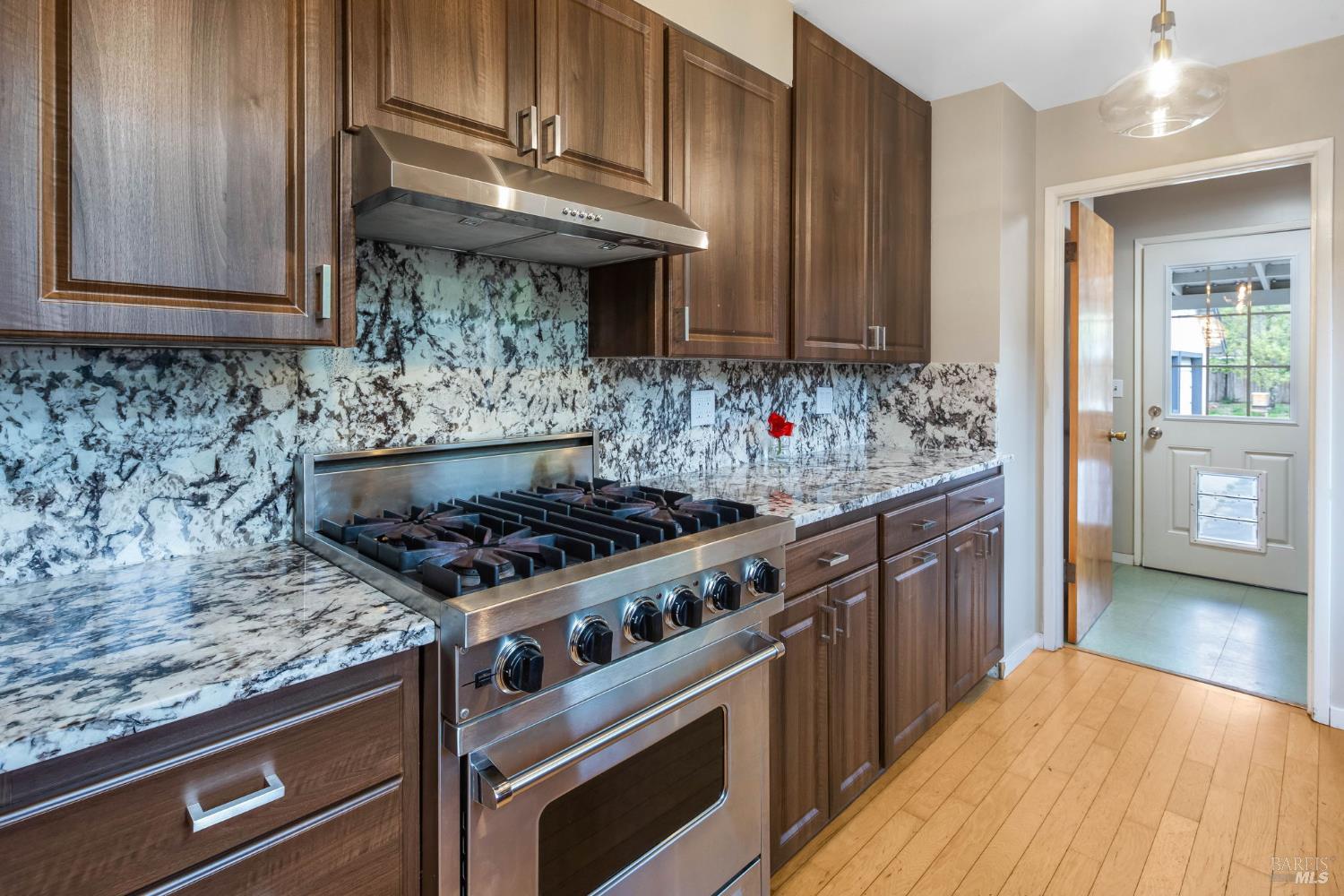 350 Newton Way Angwin, CA 94508 - Photo 15 of 44 a kitchen with granite countertop a stove and a wooden cabinets
