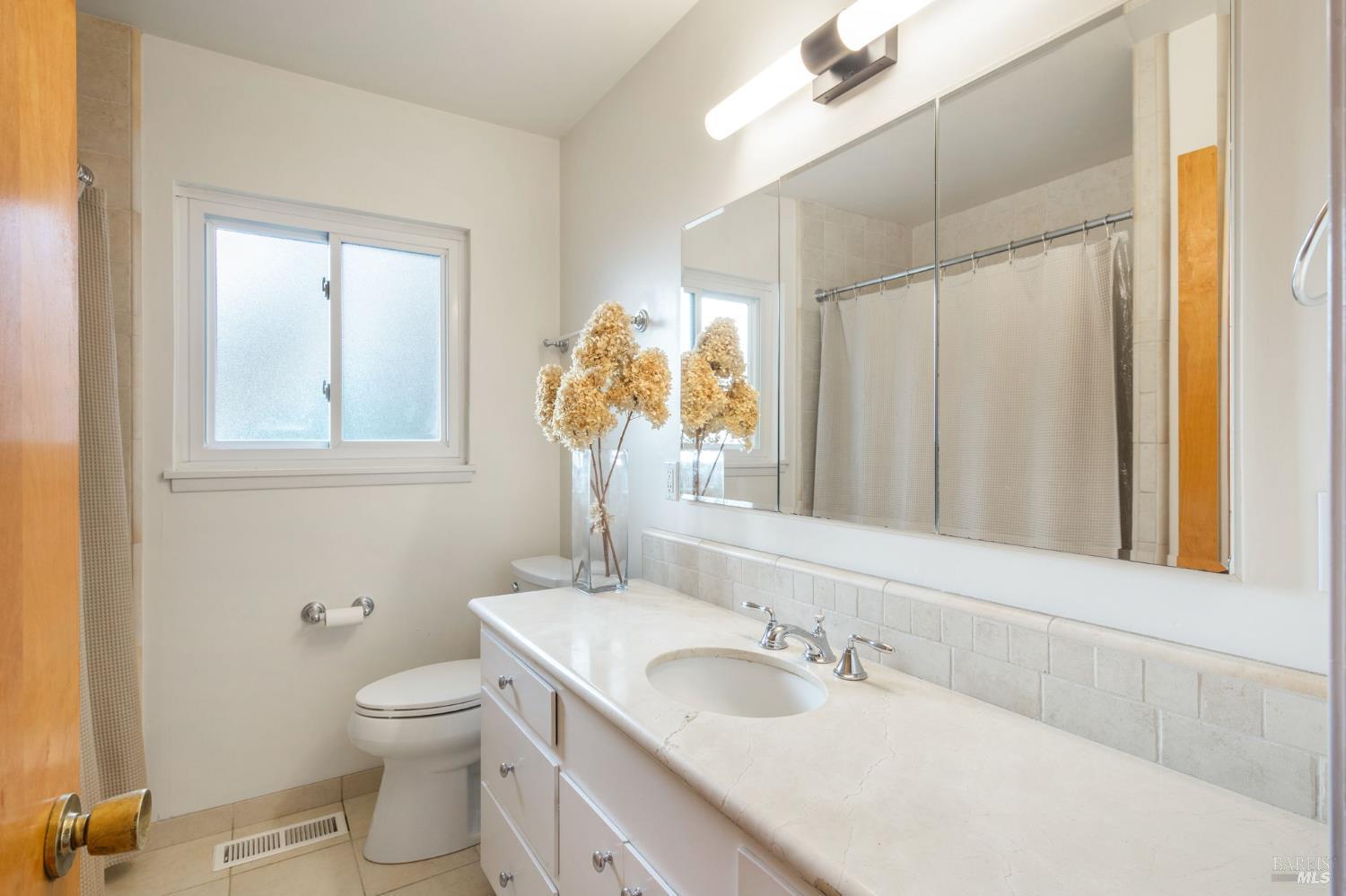 350 Newton Way Angwin, CA 94508 - Photo 20 of 44 a bathroom with a granite countertop sink a toilet and a mirror