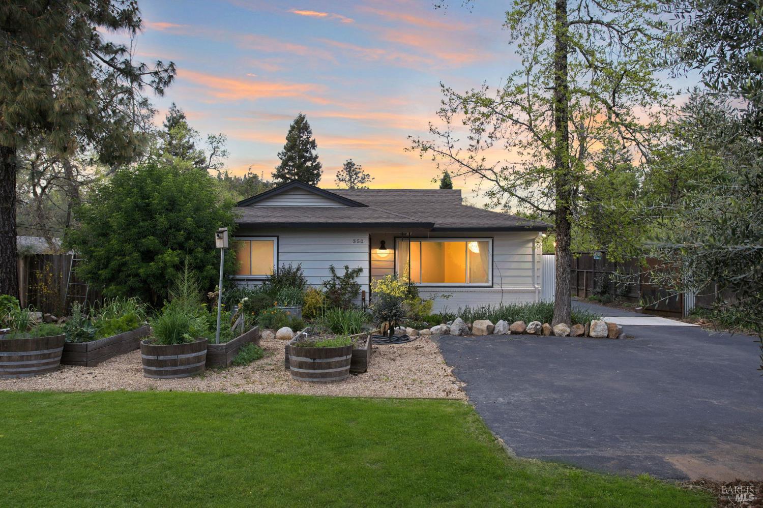 350 Newton Way Angwin, CA 94508 - Photo 2 of 44 a view of a patio with table and chairs potted plants and large tree