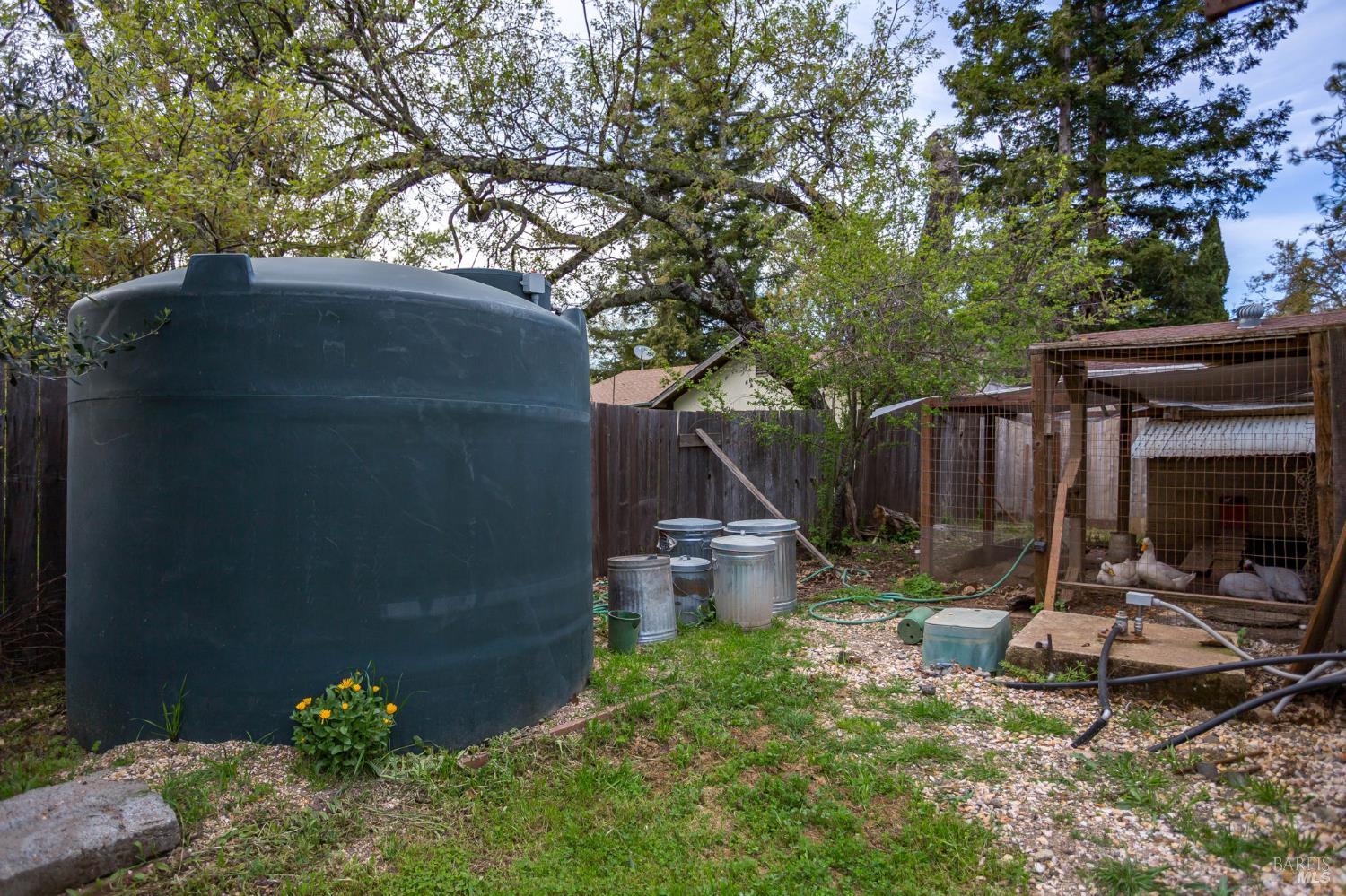 350 Newton Way Angwin, CA 94508 - Photo 37 of 44 a backyard of a house with barbeque oven and a table and chairs