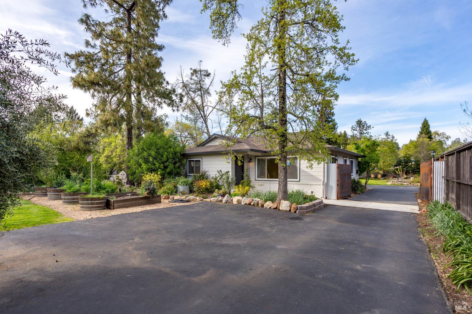 350 Newton Way Angwin, CA 94508 - Photo 5 of 44 a view of a patio with table and chairs under an umbrella