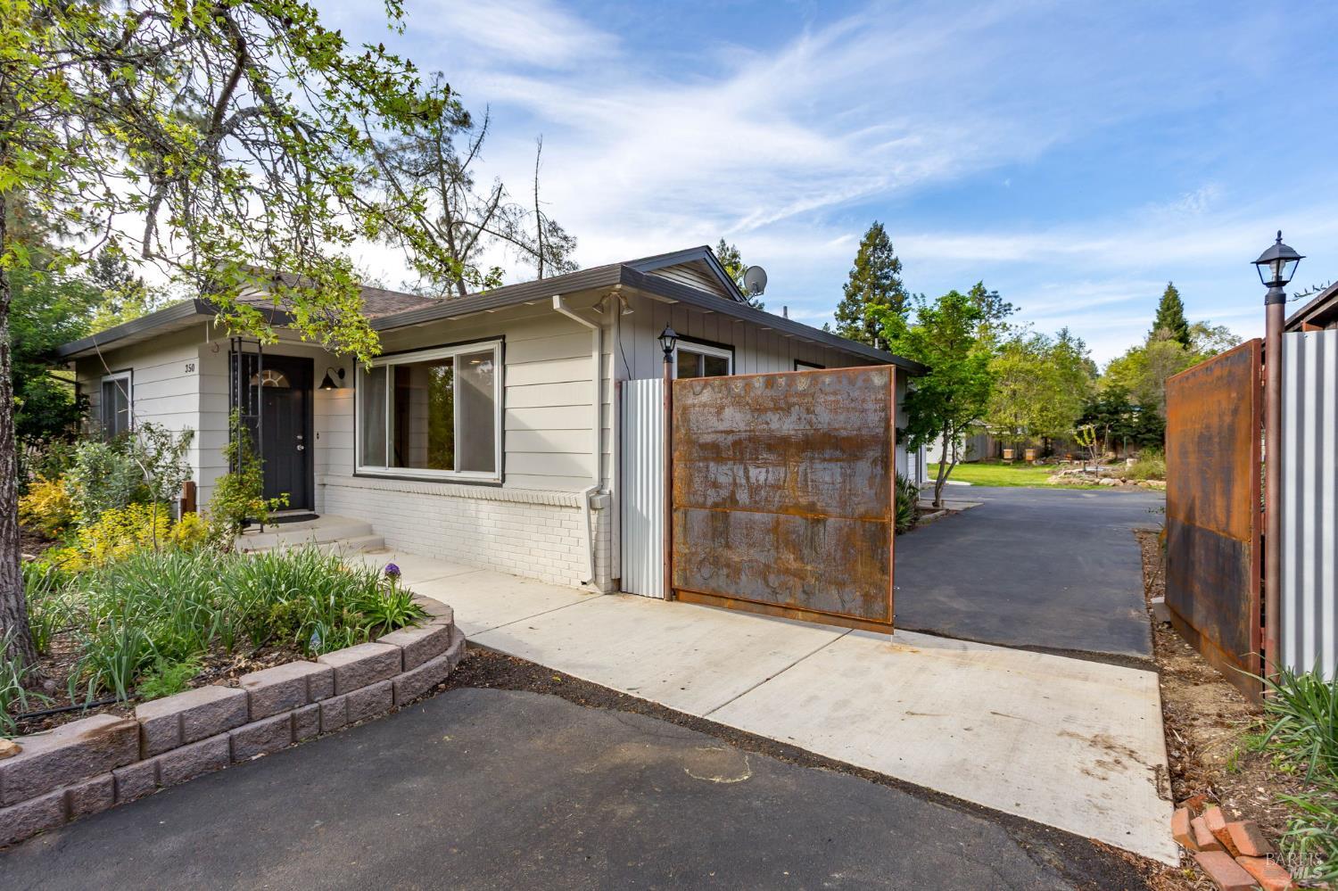 350 Newton Way Angwin, CA 94508 - Photo 6 of 44 a front view of a house with a yard and garage