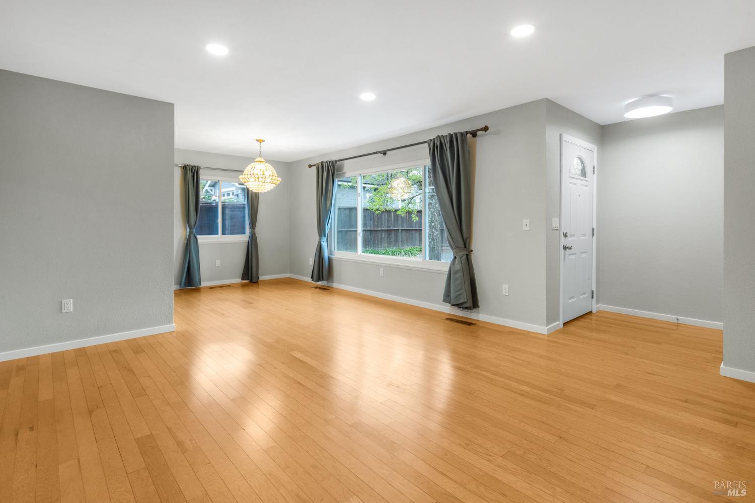 350 Newton Way Angwin, CA 94508 - Photo 10 of 44 an empty room with wooden floor and windows