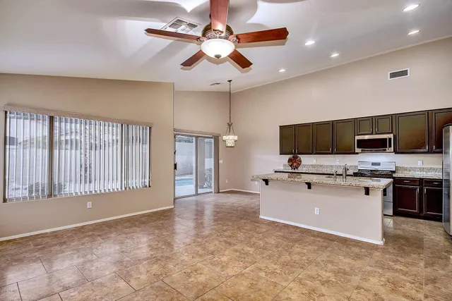 a view of kitchen with microwave stove top oven and cabinets