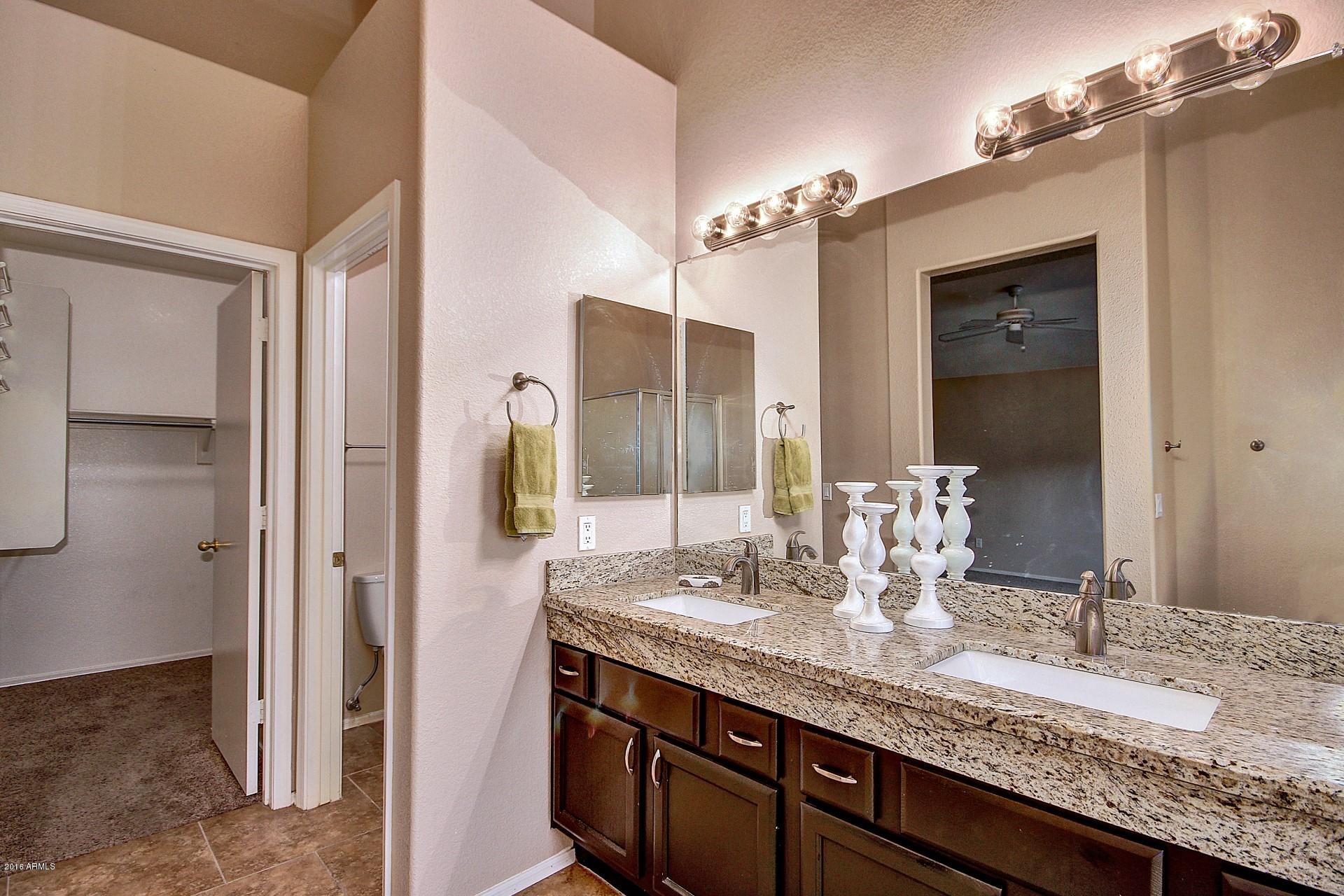 16056 South 18th Avenue Phoenix, AZ 85045 - Photo 26 of 37 a bathroom with a granite countertop sink and a mirror