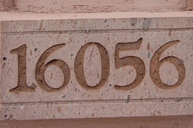 a bathroom with washing machine and mirror