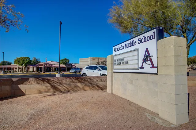 a view of a street with tables and chairs