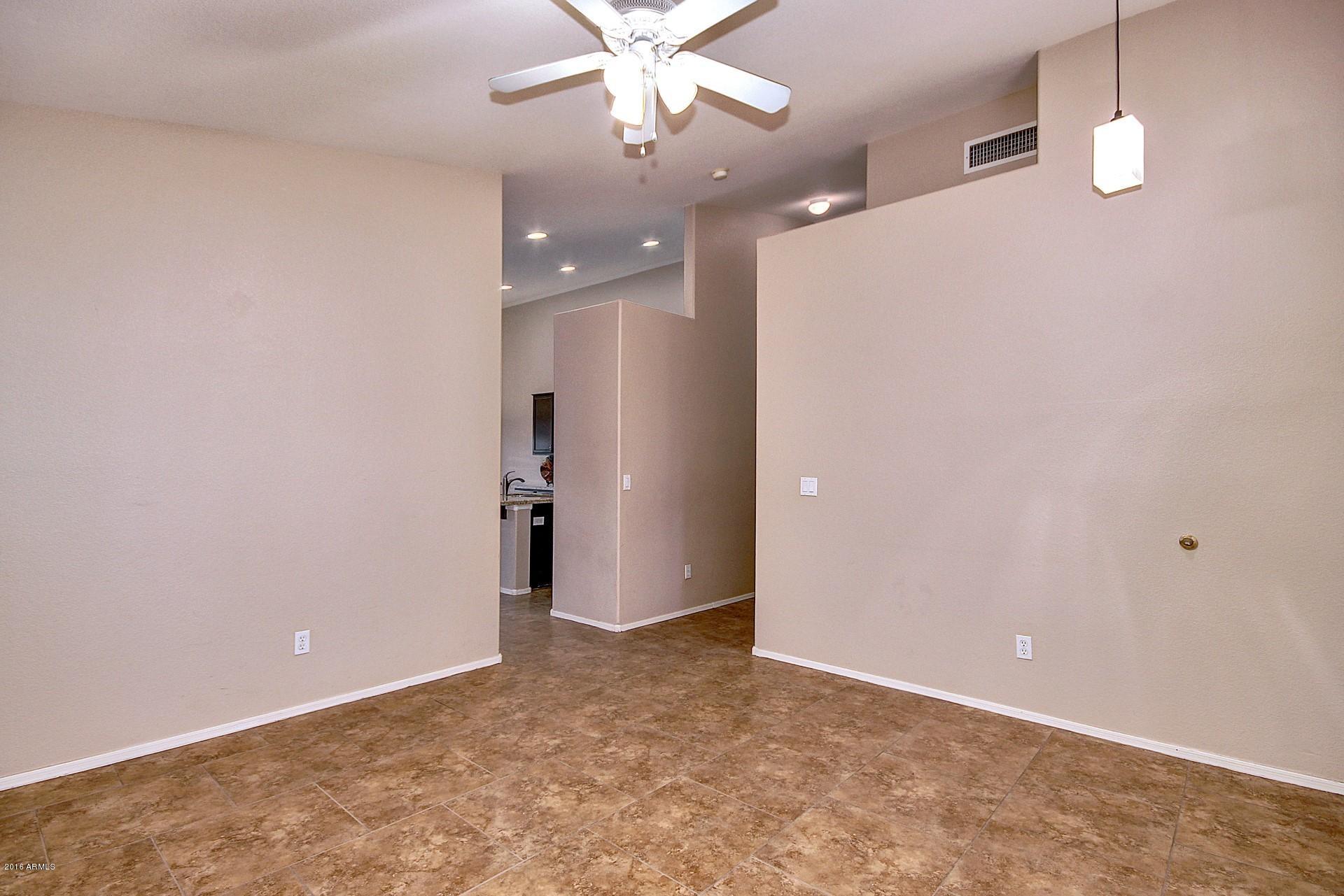 16056 South 18th Avenue Phoenix, AZ 85045 - Photo 9 of 37 an empty room with a ceiling fan and a window